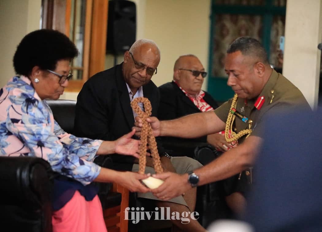 RFMF commander Jone Kalouniwai presents matanigasau to high chief Ro Teimumu Kepa at Queen Elizabeth Barracks, addressing military involvement in Fiji's coups.