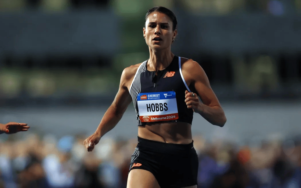 Zoe Hobbs, wearing a New Zealand athletic uniform running at an international athletics event.