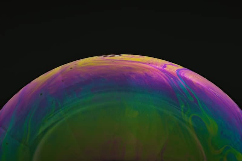 Close-up of a colorful soap bubble with iridescent patterns.