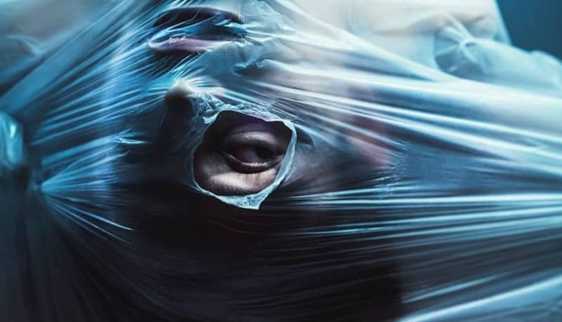 man stuck behind plastic