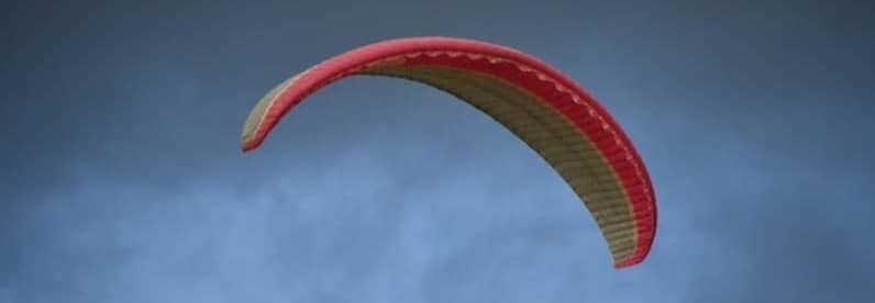 Paraglider against a blue sky