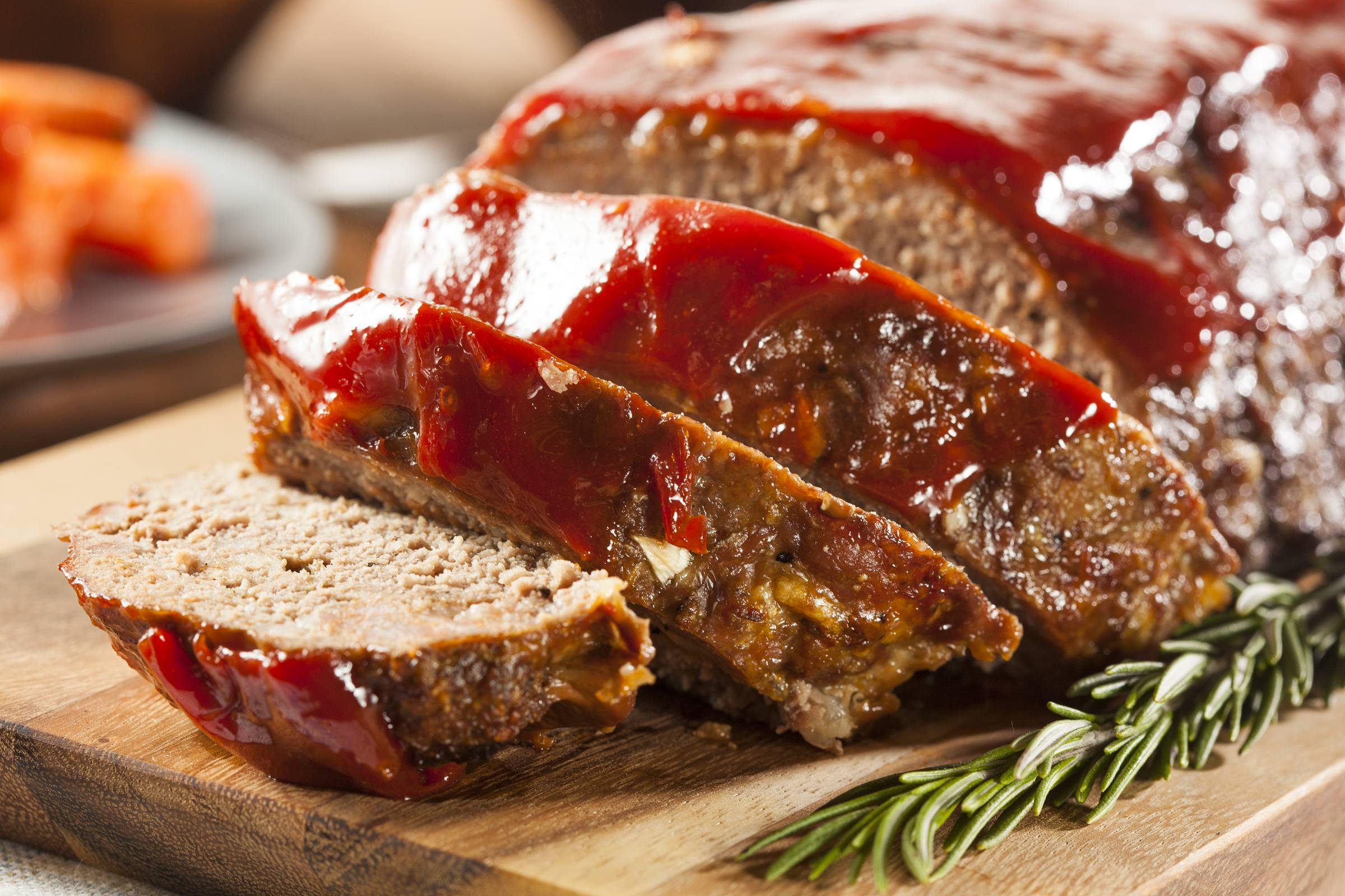 sliced meatloaf on a wooden platter