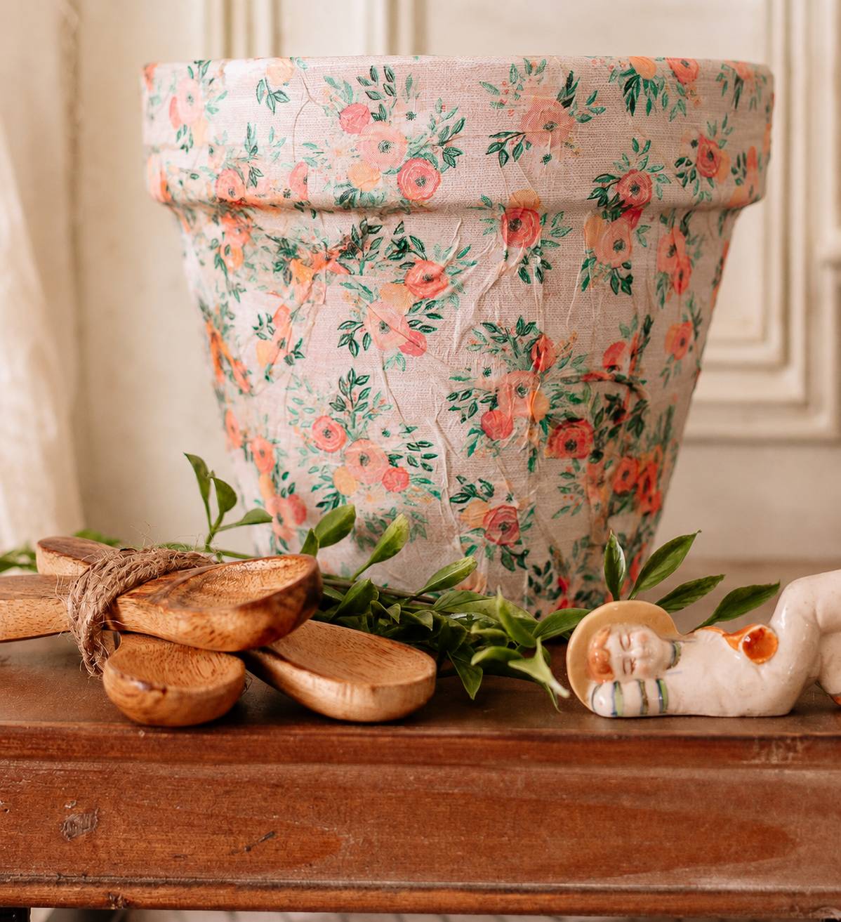 close up of a terracotta planter with a napkin decoupaged to it 