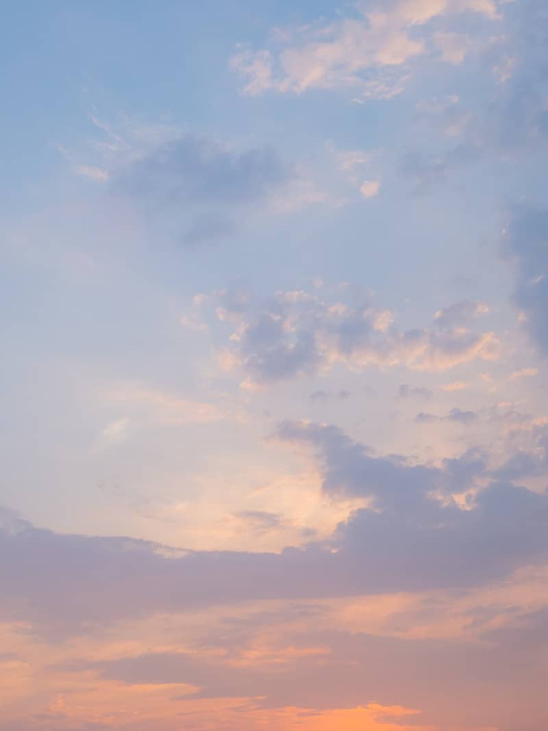 The sky contains pink, orange, and blue clouds.