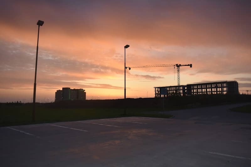 Construction site and buildings at sunset