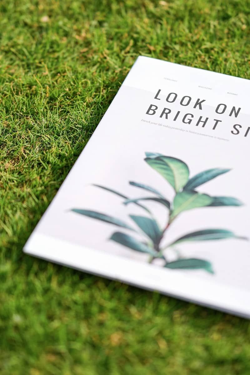 Magazine on grass with plant illustration