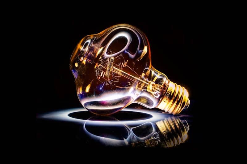 A melting lightbulb with a glowing filament.