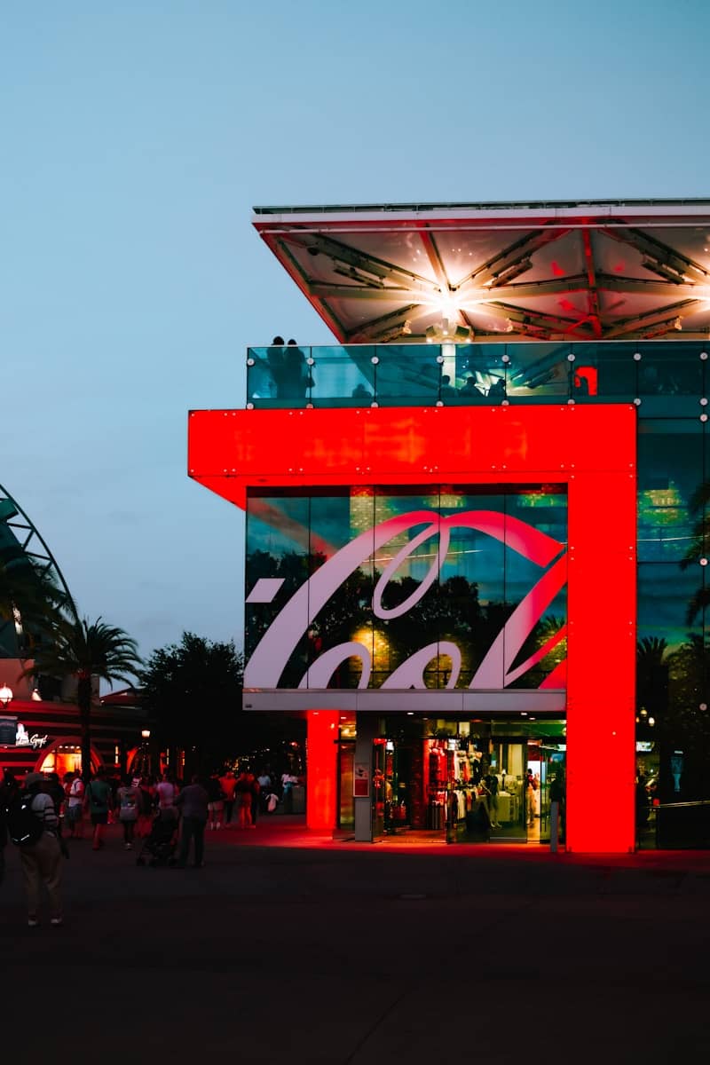 The coca-cola store glows brightly at dusk.