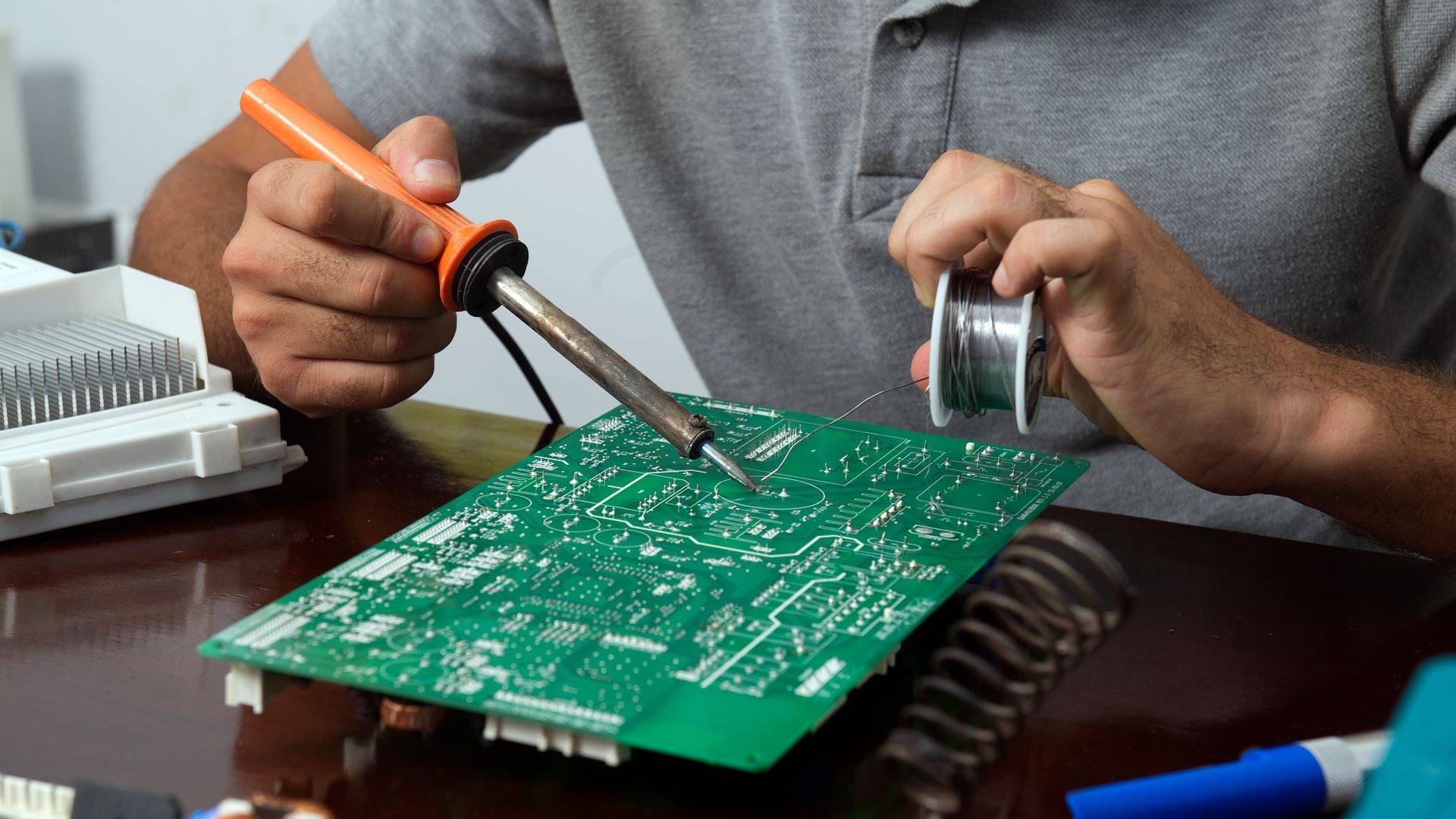 Hand-soldering a circuit board