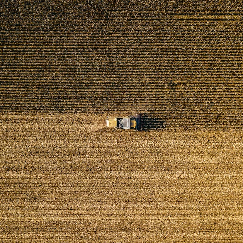 an aerial view of a farm house in a field