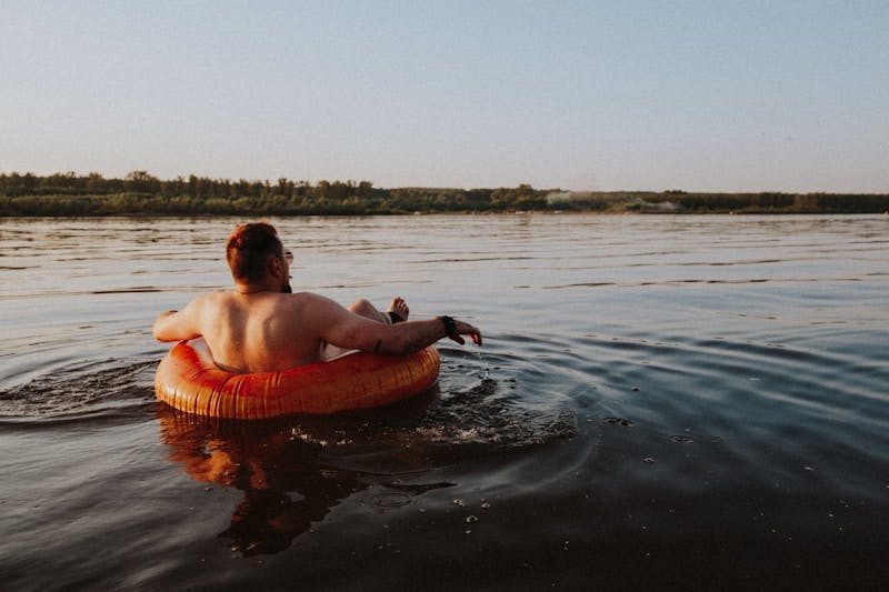 man in inflatable tube on water 