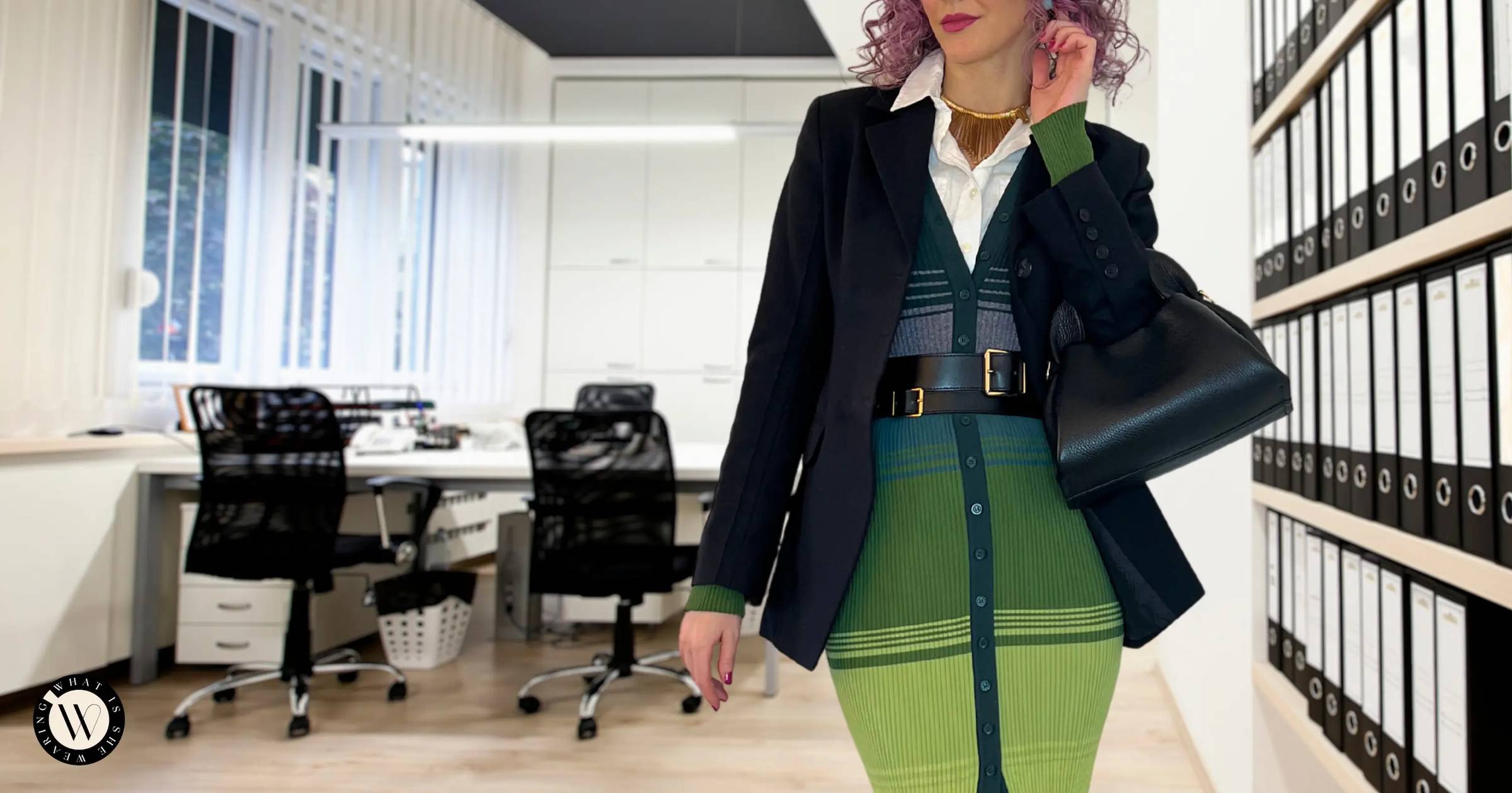 A stylish woman in a chic work outfit in an office.