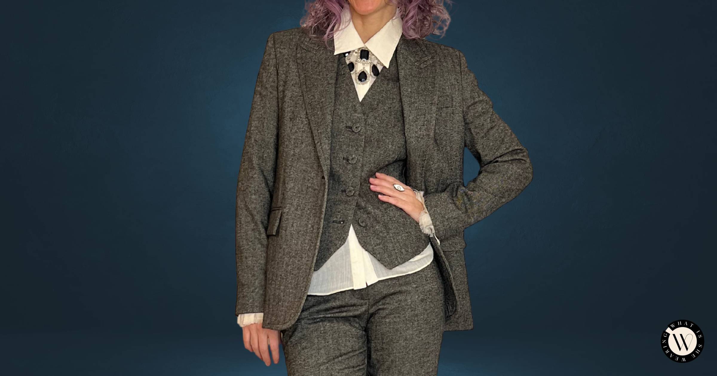 A woman in a timeless outfit featuring a 3-piece suit, showcasing a timeless trend of tailoring.