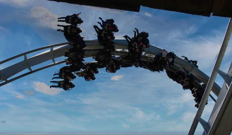 Roller coaster riders upside down on a track