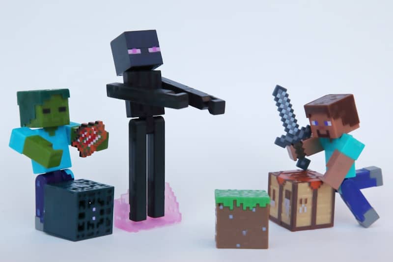 Minecraft action figures including a zombie, an enderman, and Steve with a sword
