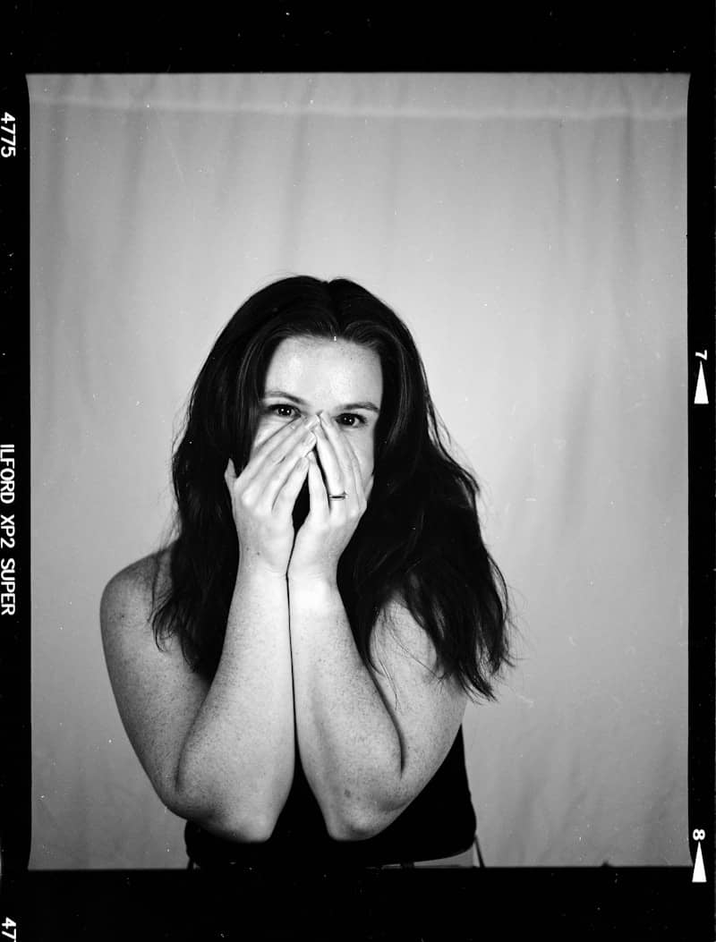 Woman covering her mouth and nose with hands