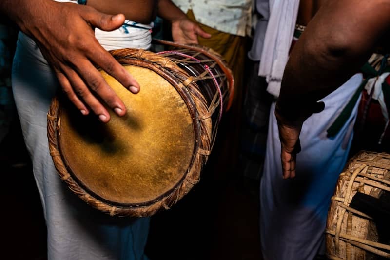 Musician playing a traditional hand drum.