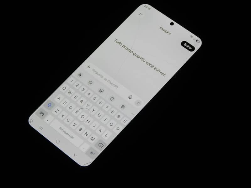 A smartphone screen displaying a chat interface with a virtual keyboard on black