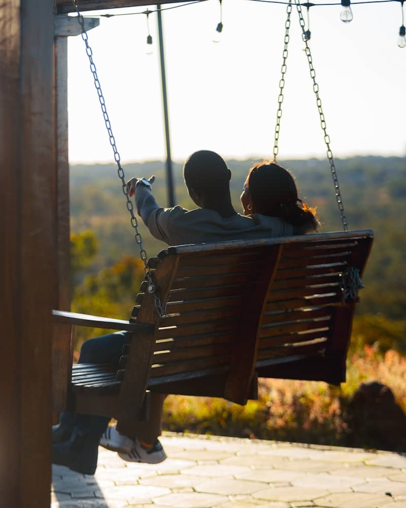 Couple enjoys a swing with scenic views.