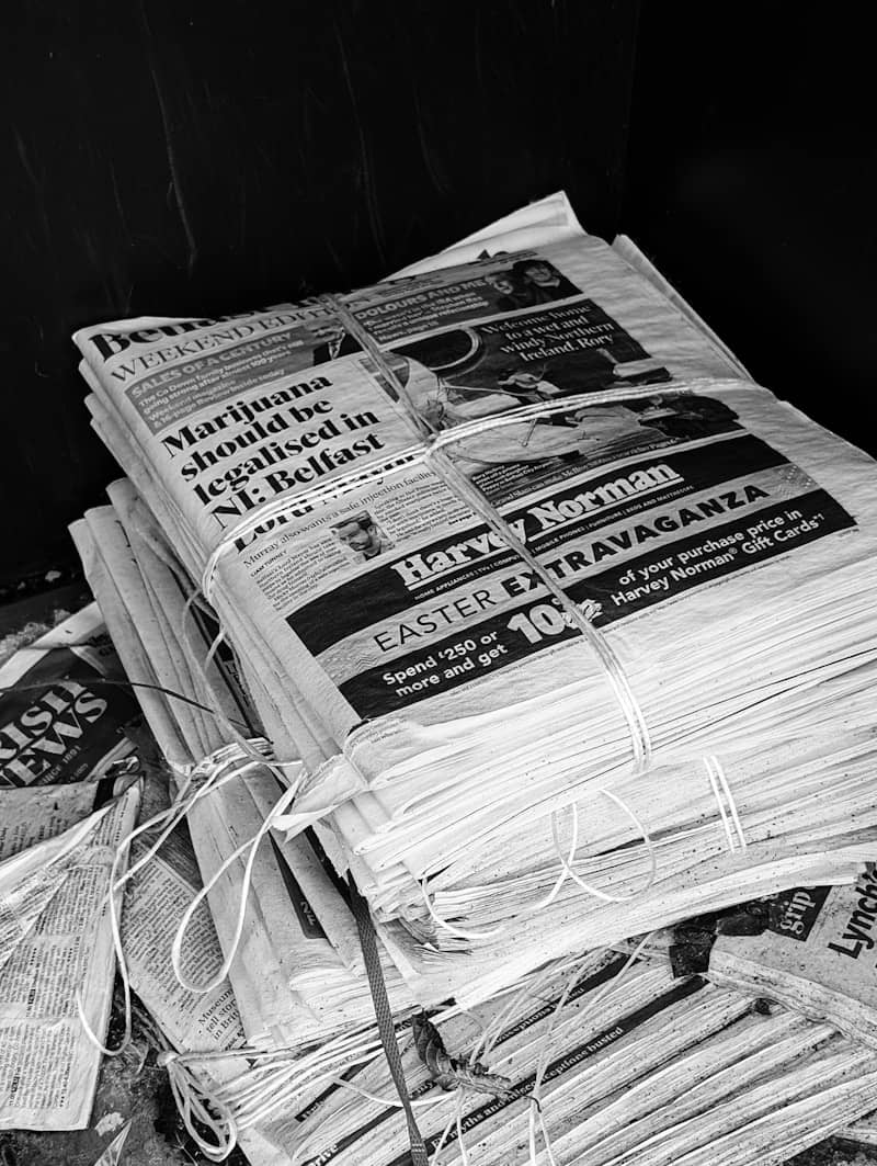 A stack of newspapers tied together with string.