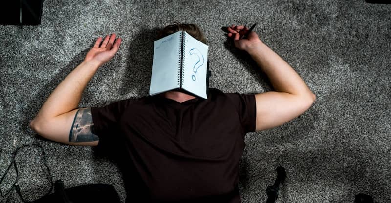 person in black shirt holding white paper