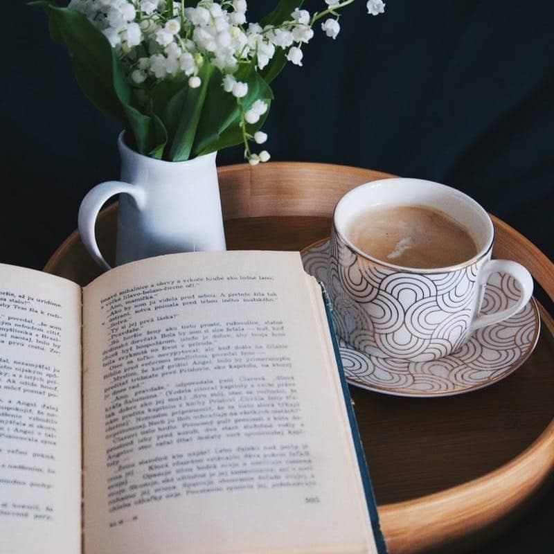 white and blue ceramic mug on brown wooden table