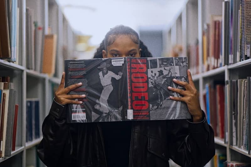 Woman holding a record album in a library