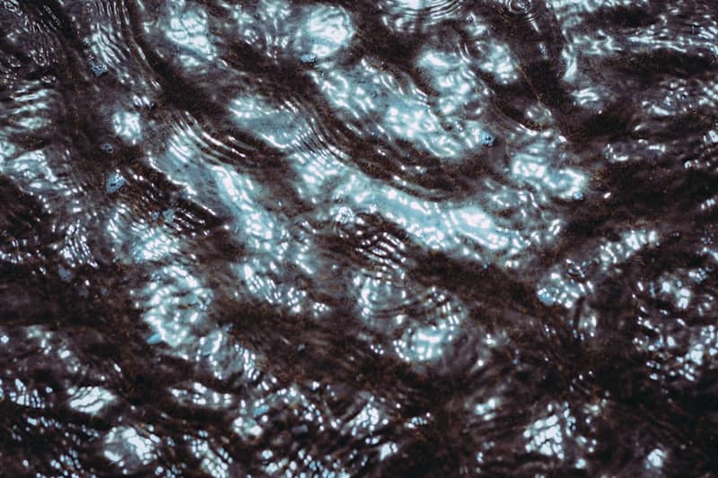 Rippling dark water with bright light reflecting on the surface