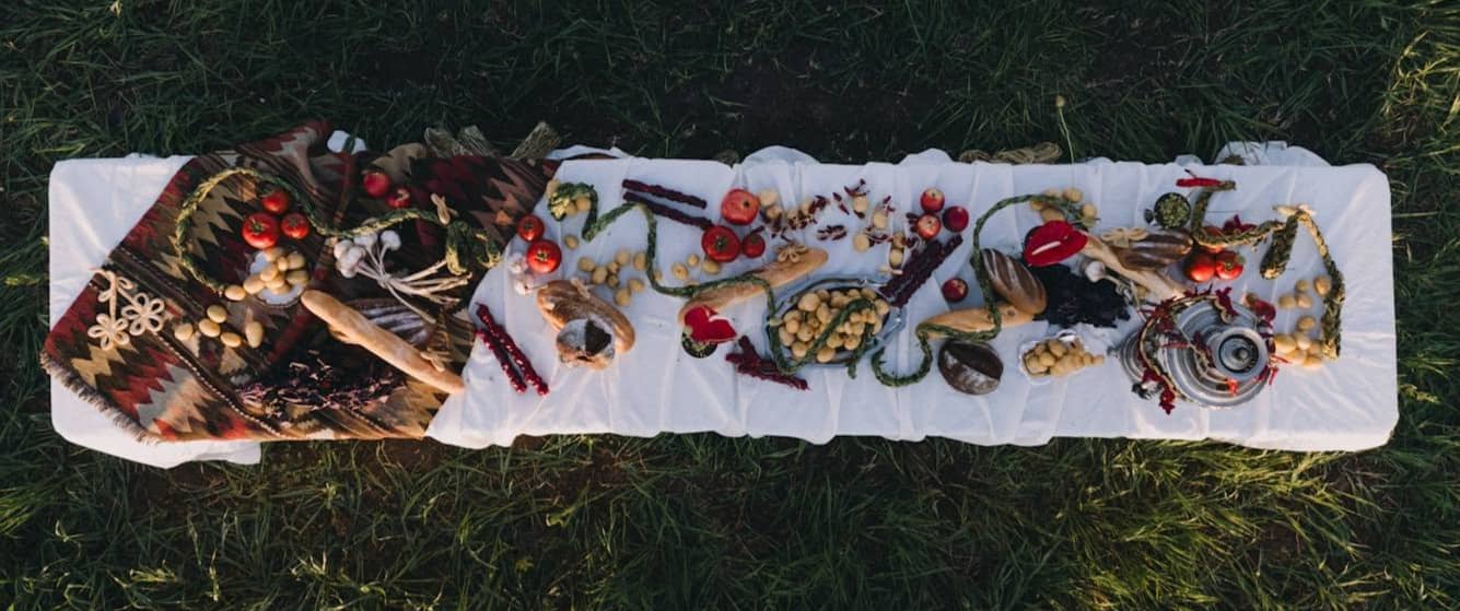 Food and other items are artfully arranged on a cloth.