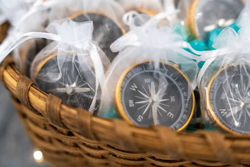 Compasses are gifts in white mesh bags.