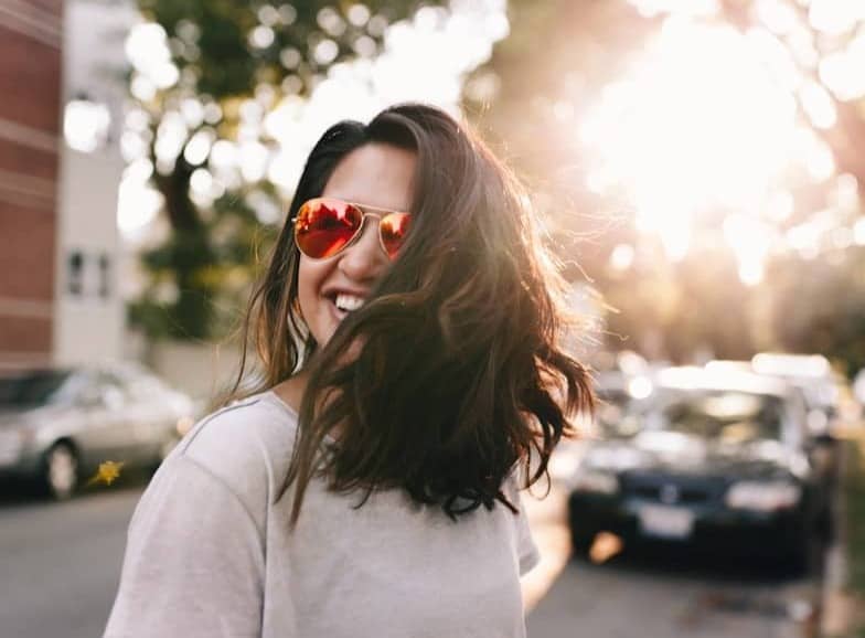 woman wearing white T-shirt smiling