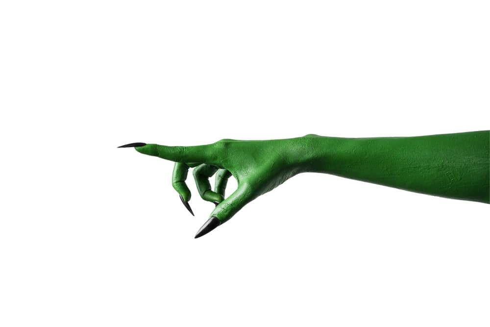 A green witch, Elphaba, pointing her finger