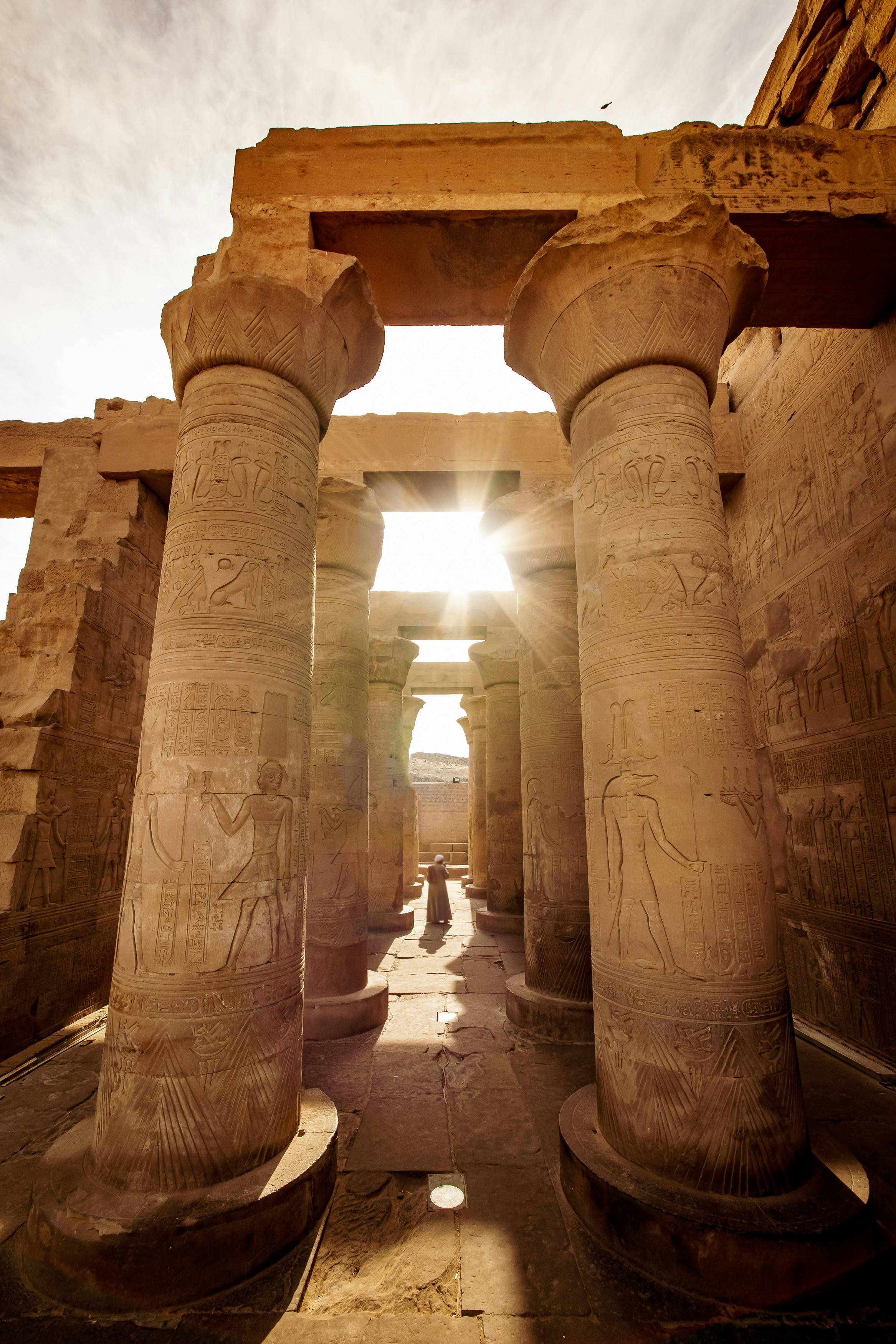Light shining through temple pillars in Egypt