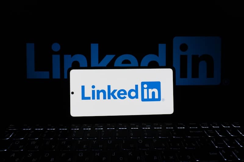 A phone displays the linkedin logo.