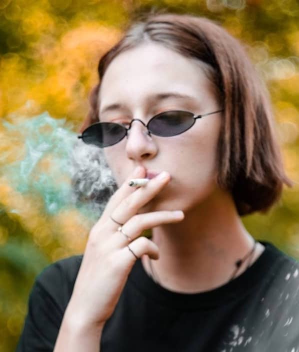 time-lapse photography of woman smoking cigarette