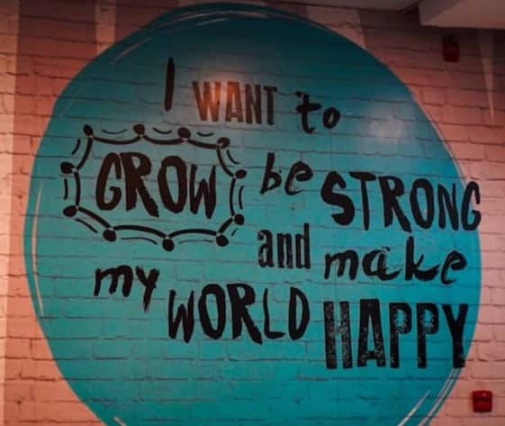 Wall mural with inspirational quote about growth and happiness
