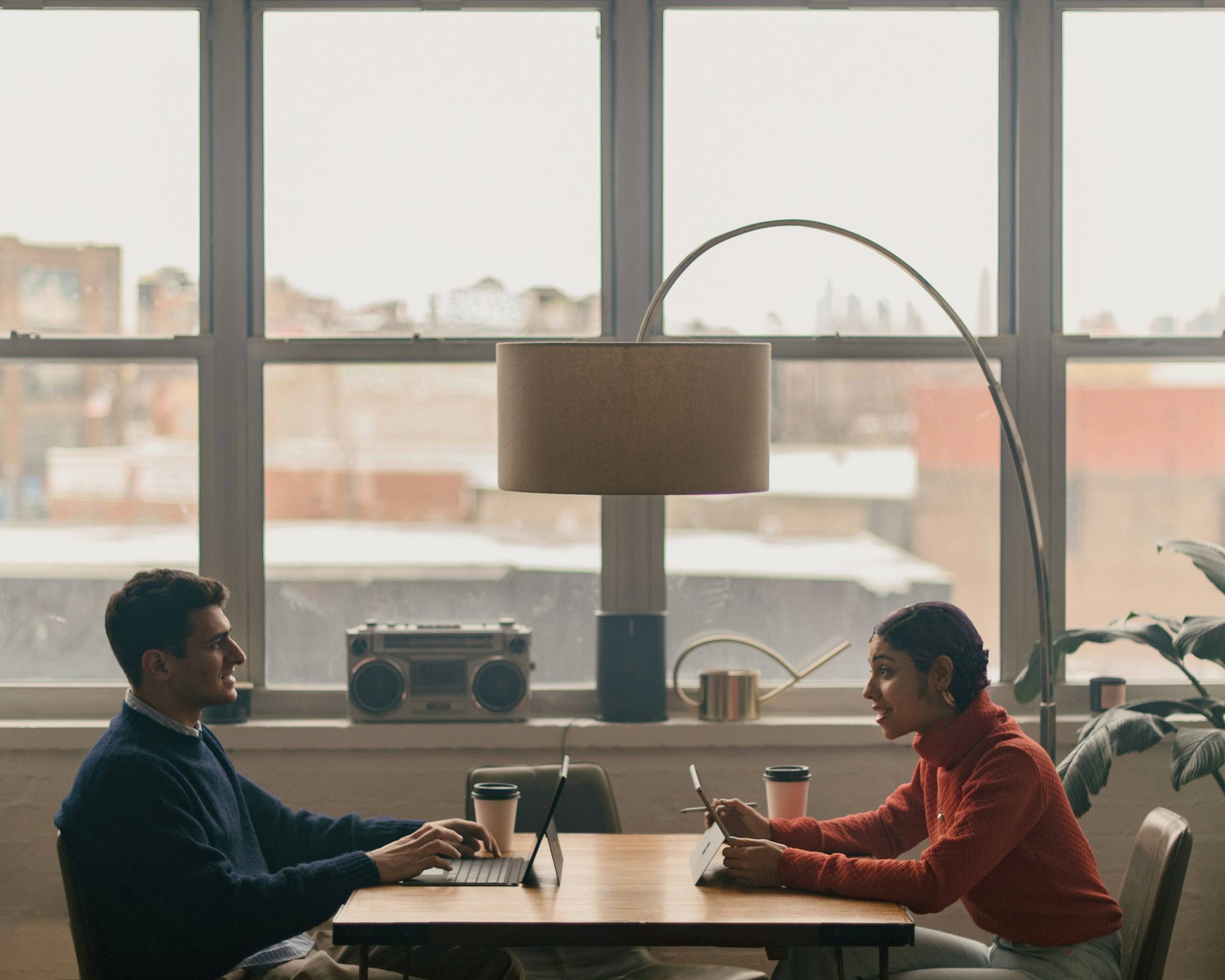 Couple discussing daily priorities over coffee with open calendar
