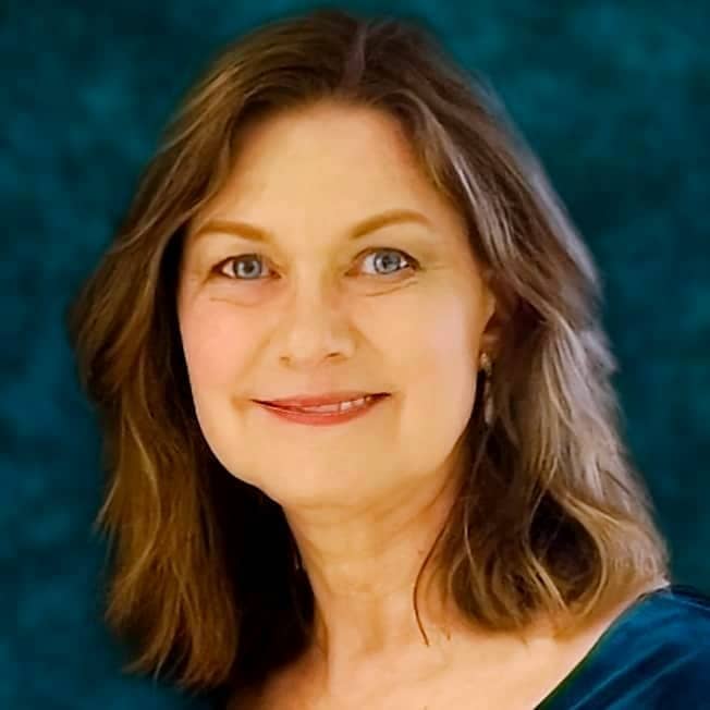 Head-and-shoulder photograph of Vicki, a middle aged caucasian woman with shoulder length brown hair