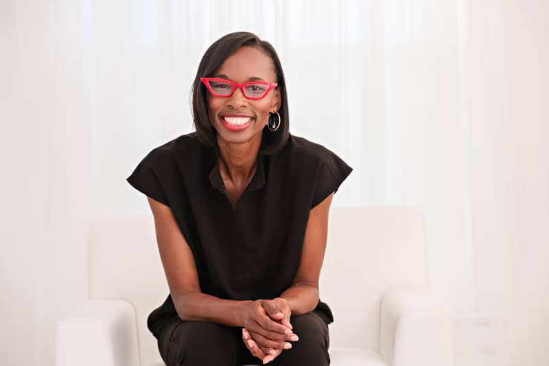 radiologic technologist smiling in black scrubs