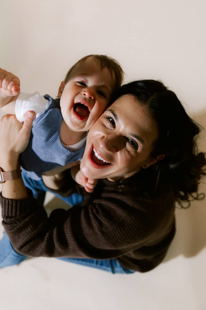 Mother and baby laughing together joyfully