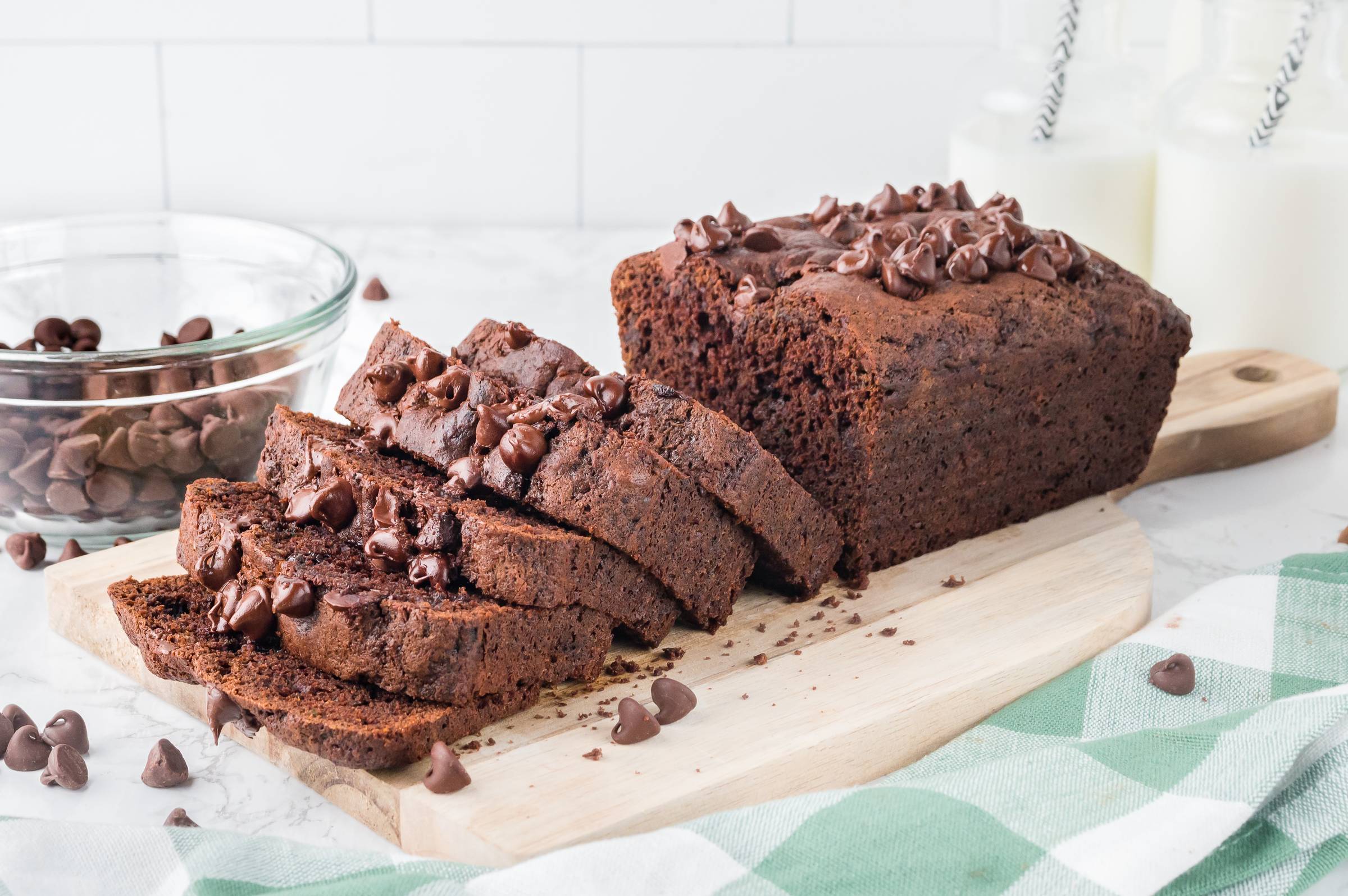 Chocolate zucchini bread cut into slices on a cutting board.