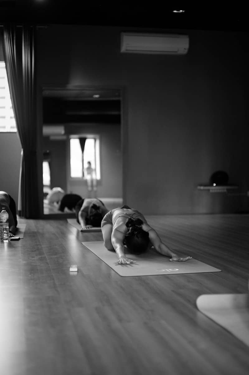 a group of people doing yoga in a room