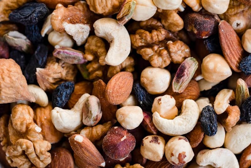 A close-up view of a mixed nut and raisin blend.
