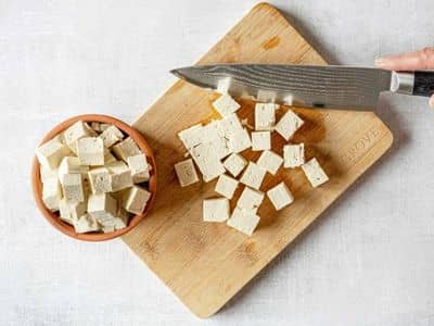 chopping tofu on cutting board