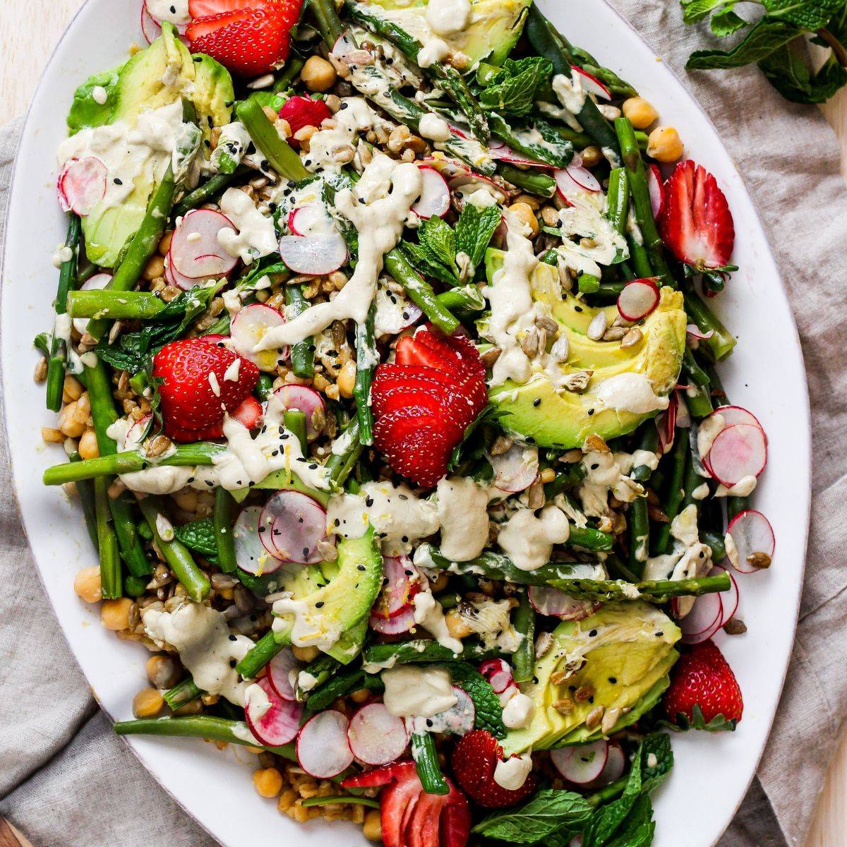 spring farro salad with strawberries, avocado, and tahini dressing