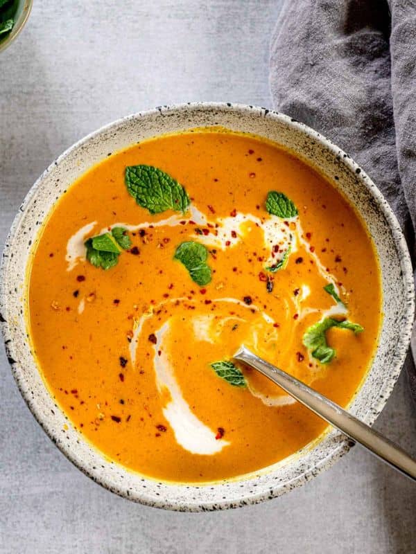 Pumpkin soup with coconut milk, fresh herbs, and red pepper.
