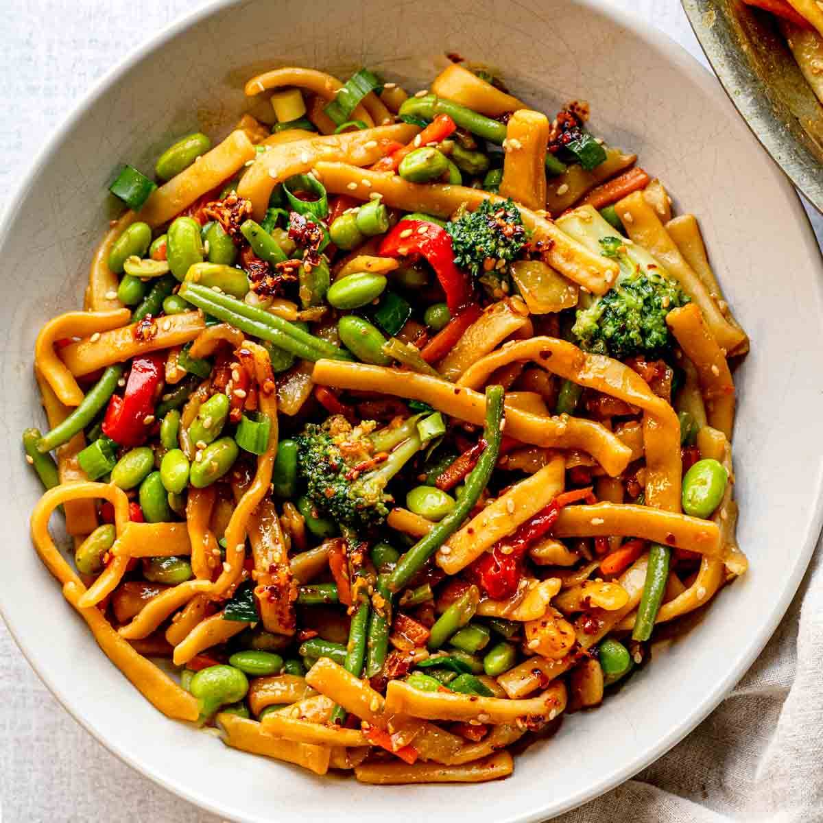 Vegetable stir-fry with noodles and edamame.