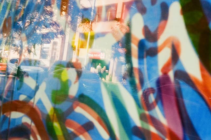 Abstract colorful graffiti with reflections of street scene