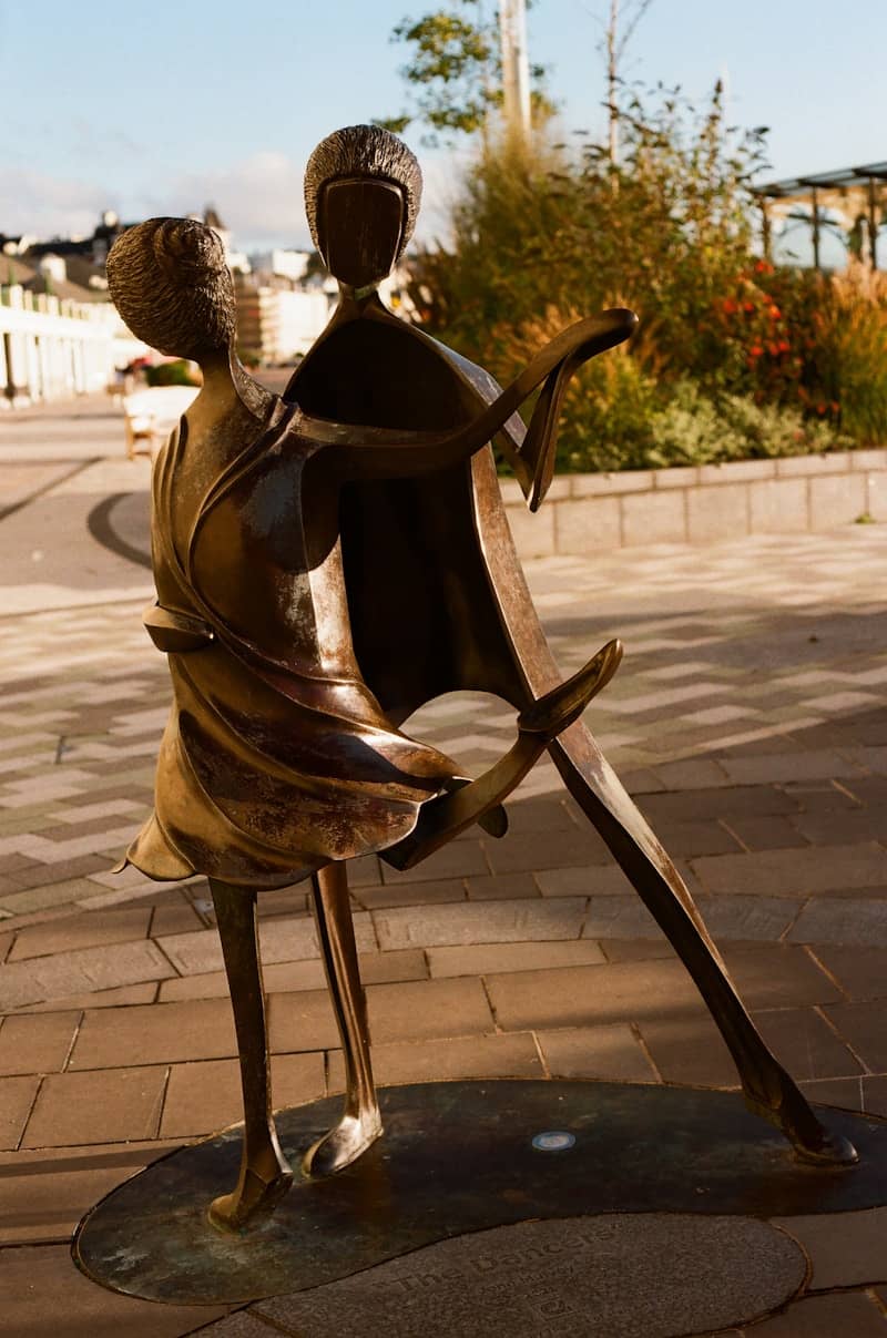 Bronze sculpture of a dancing couple outdoors