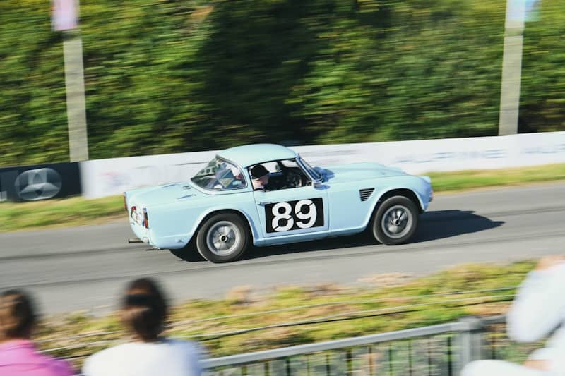 Light blue vintage race car with number 89